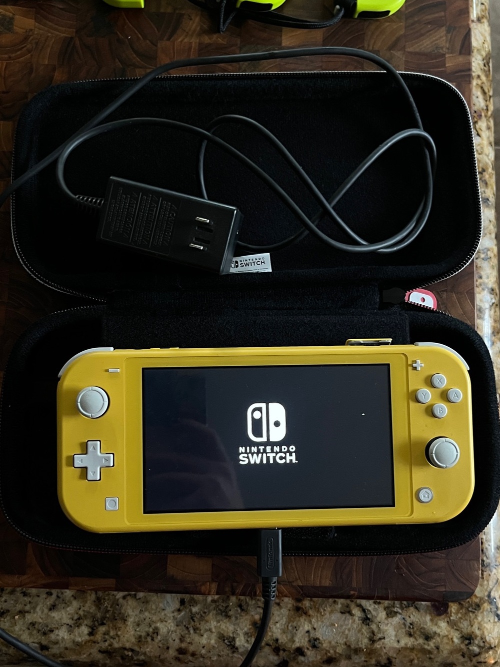 Nintendo Switch Lite Yellow: comes with charger, carrying case, and game holders